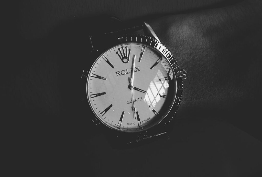 Round White Silver-colored Rolex Analog Watch Displaying 4:03 Time